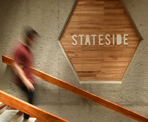 Employee coming down the stairs | Stateside office